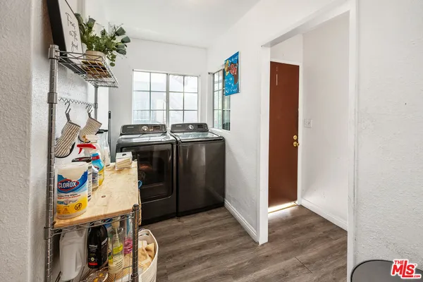 a view of a storage & utility room with refrigerator and toys