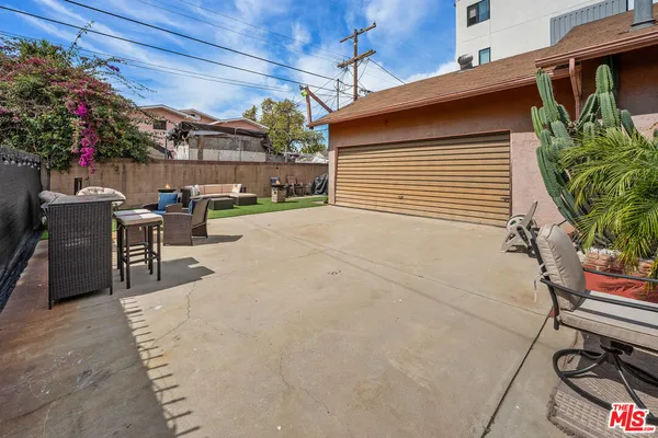 a view of a backyard with sitting area