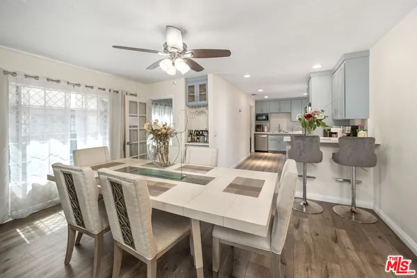 a view of a dining room with furniture and wooden floor