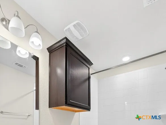 a bathroom with a mirror and a shower