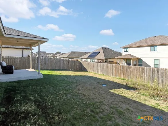 a view of backyard with swimming pool