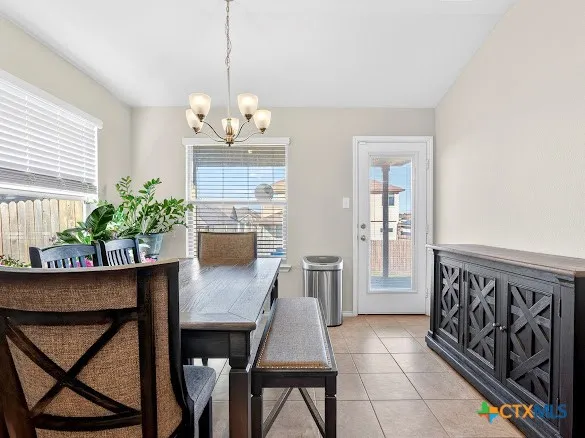 a view of a dining room with furniture and a chandelier