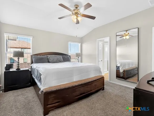 a spacious bedroom with a bed and a large window