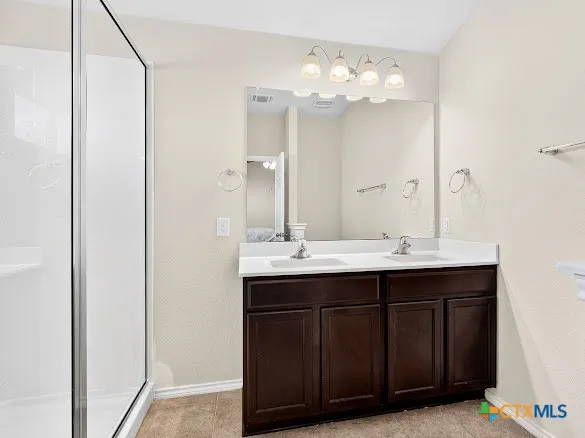 a bathroom with a double vanity sink and a mirror