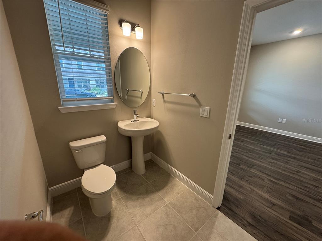 16434 Hamlin Hills Road Winter Garden, FL 34787 - Photo 7 of 50 a bathroom with a toilet and a mirror