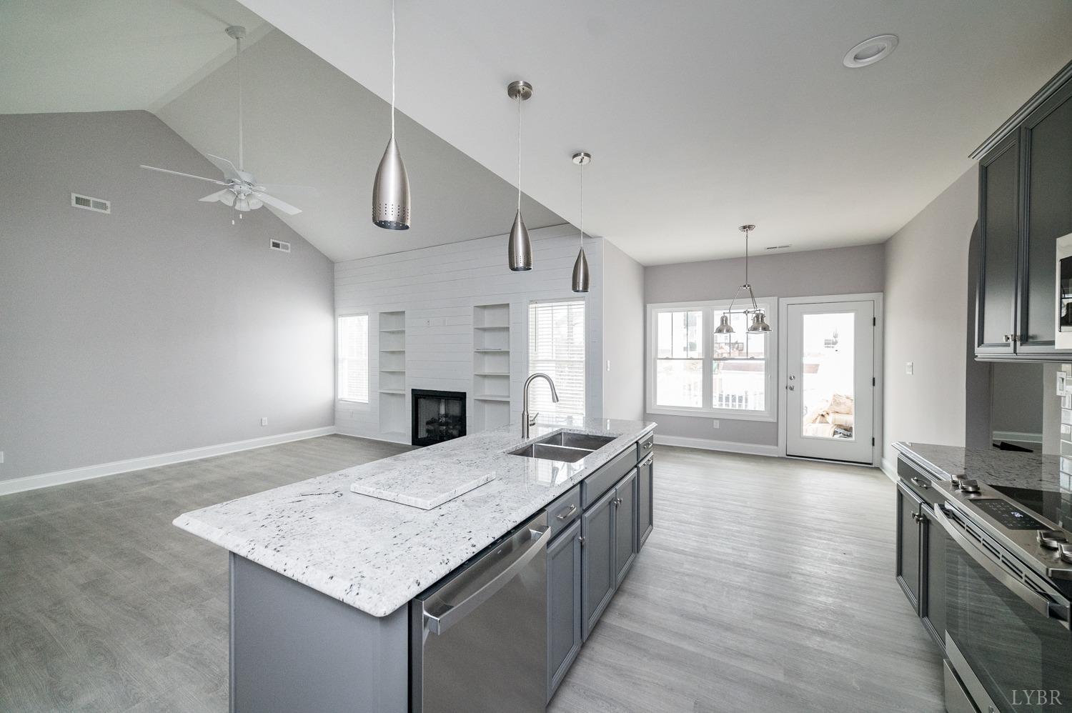1051 Wills Way Forest, VA 24551 - Photo 12 of 49 a kitchen with stainless steel appliances granite countertop a sink stove and refrigerator
