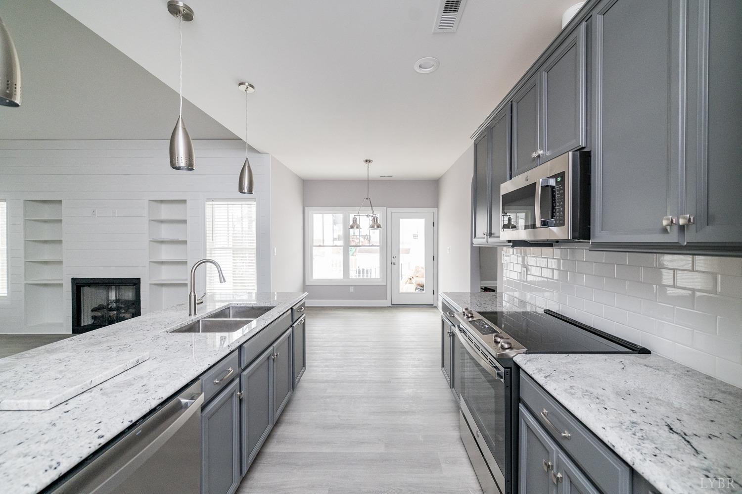1051 Wills Way Forest, VA 24551 - Photo 13 of 49 a kitchen with stainless steel appliances granite countertop a sink a stove top oven a counter space and cabinets