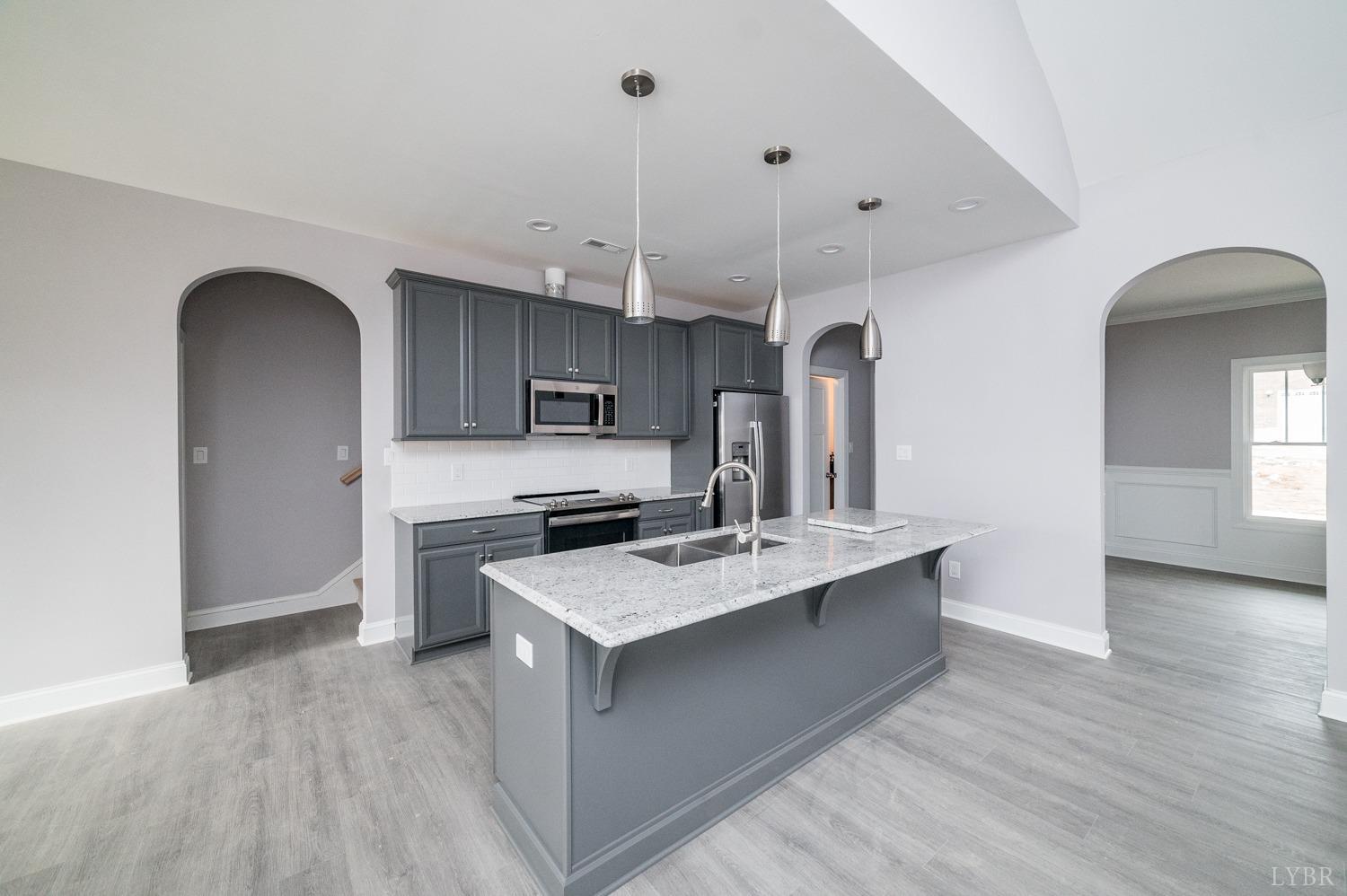 1051 Wills Way Forest, VA 24551 - Photo 2 of 49 a kitchen with kitchen island stainless steel appliances a sink a stove and refrigerator