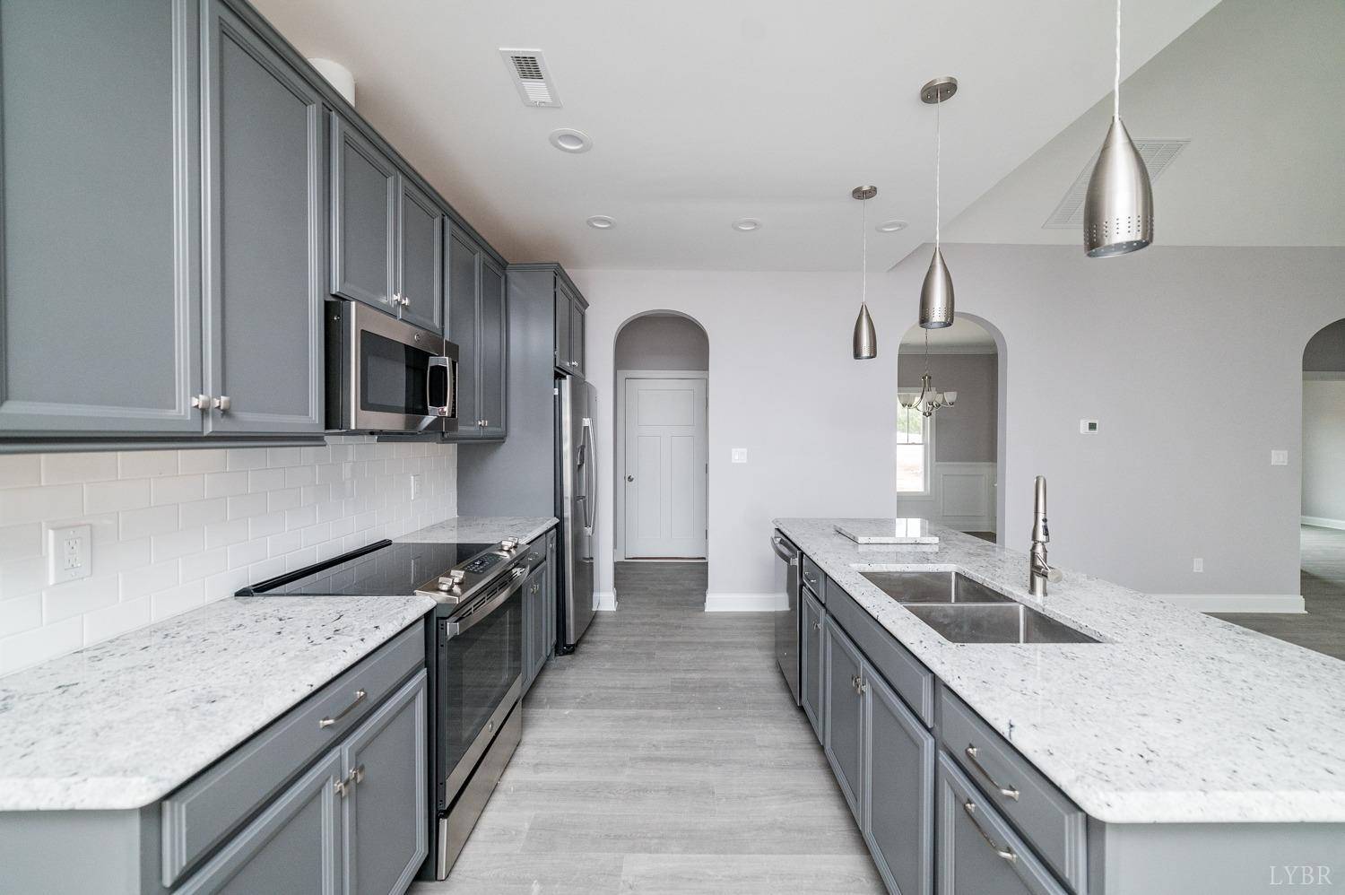 1051 Wills Way Forest, VA 24551 - Photo 4 of 49 a kitchen with stainless steel appliances granite countertop a sink and stove