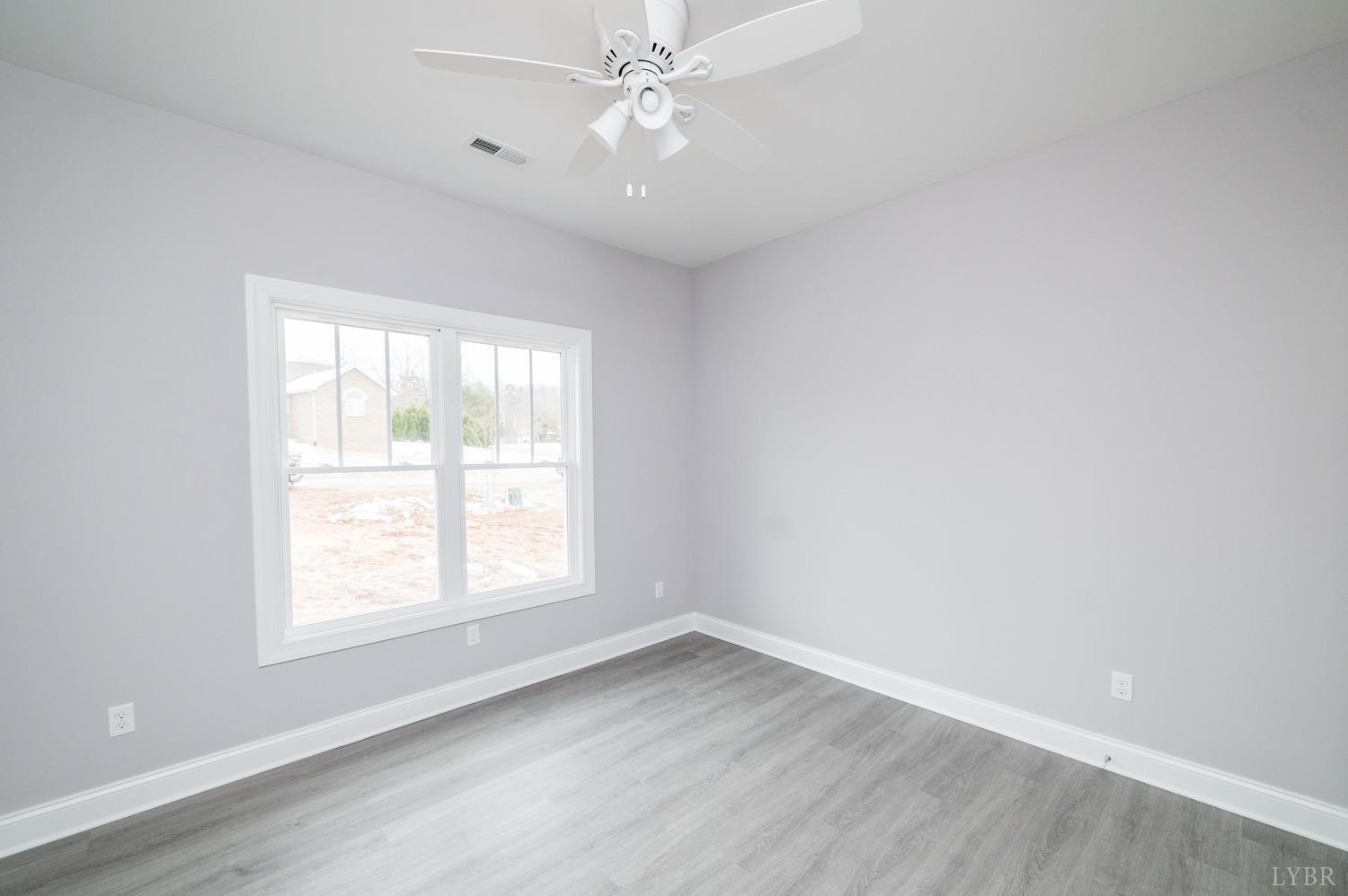 1051 Wills Way Forest, VA 24551 - Photo 41 of 49 an empty room with a window and ceiling fan