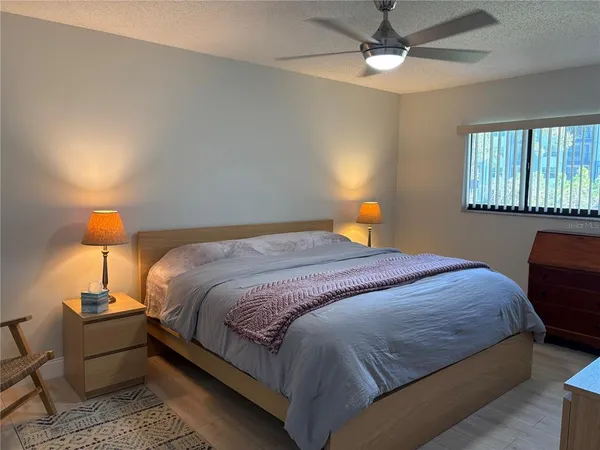 a bedroom with a bed a lamp and a lamp