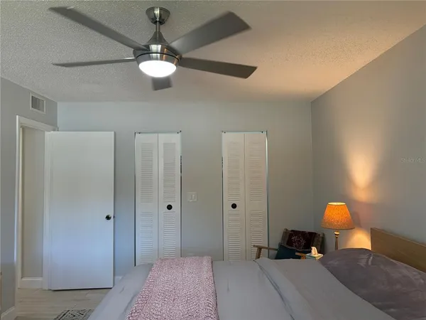 a bedroom with a bed and a chandelier