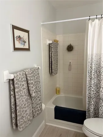 a bathroom with a toilet and shower