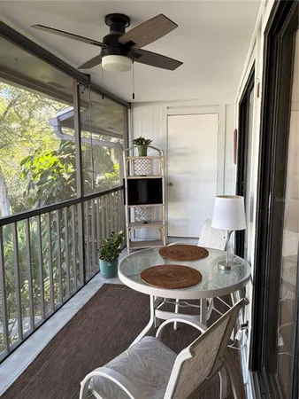 a balcony with table and chairs