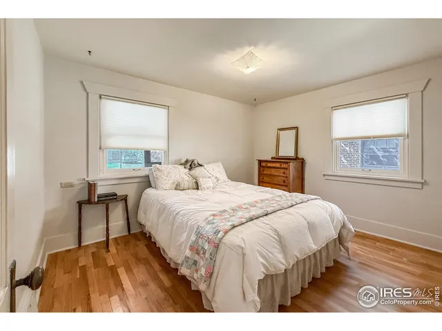 a bedroom with a bed and a tv