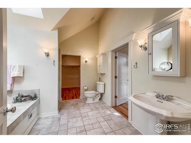 a view of a hallway with wooden floor and glass door