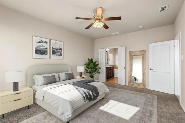 a spacious bedroom with a large bed and a chandelier