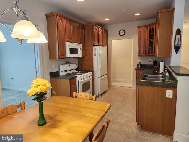 a kitchen with stainless steel appliances granite countertop a sink refrigerator and microwave