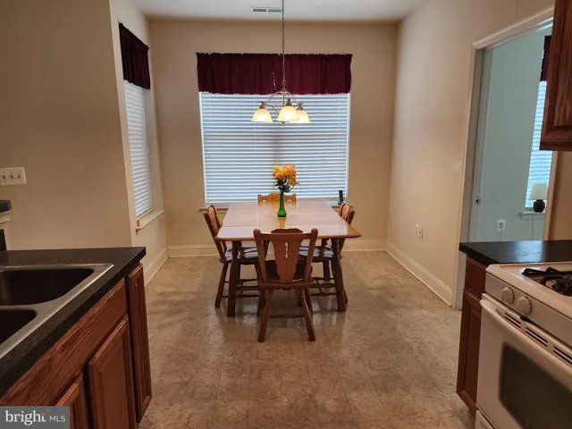 a view of a dining room with furniture and chandelier
