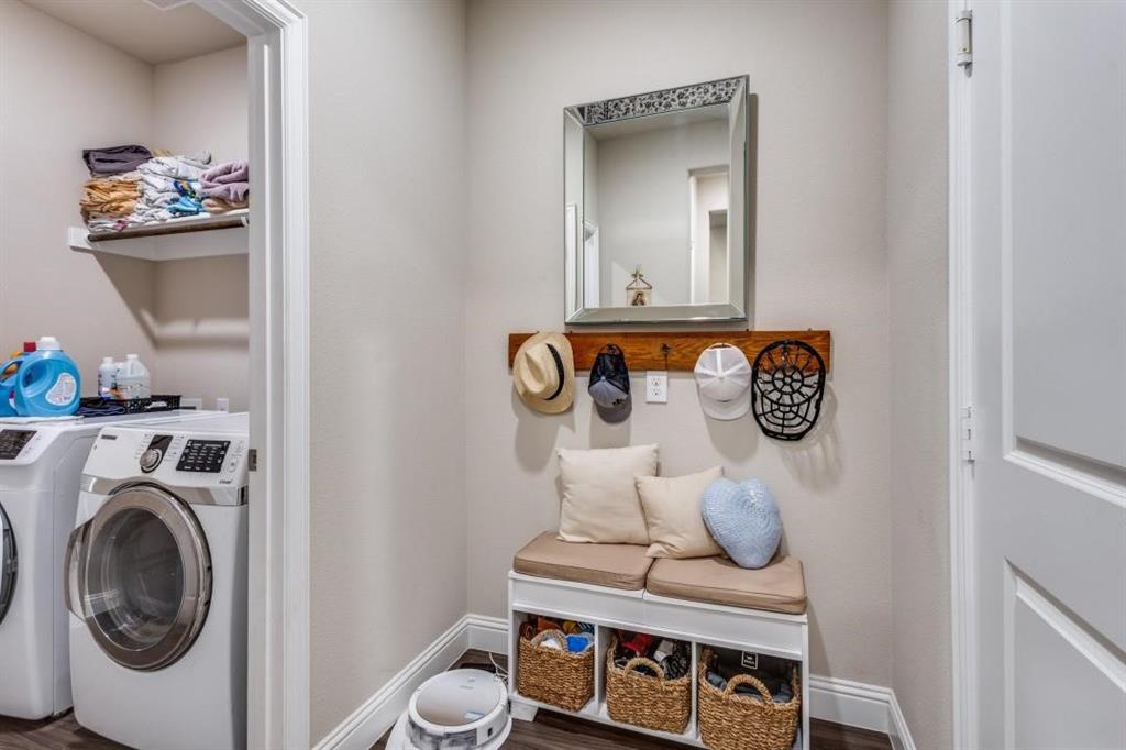 2821 Inn Kitchen Way McKinney, TX 75071 - Photo 20 of 24 Laundry area with built-in shelving, wood-finish flooring, and a dedicated storage bench with a wood-tone coat rack
