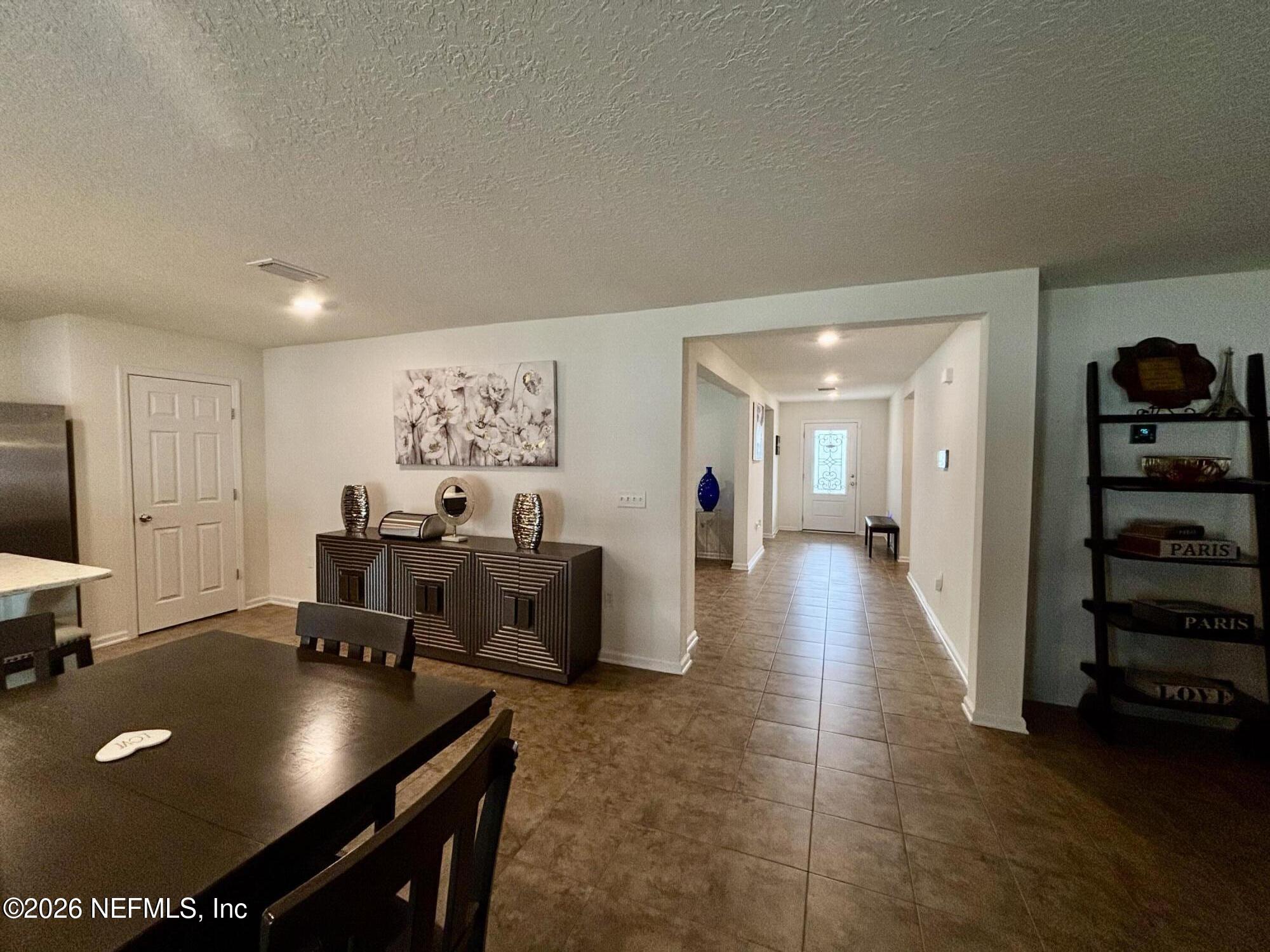 8280 Fouraker Forest Road Jacksonville, FL 32221 - Photo 6 of 25 a living room with furniture and a flat screen tv