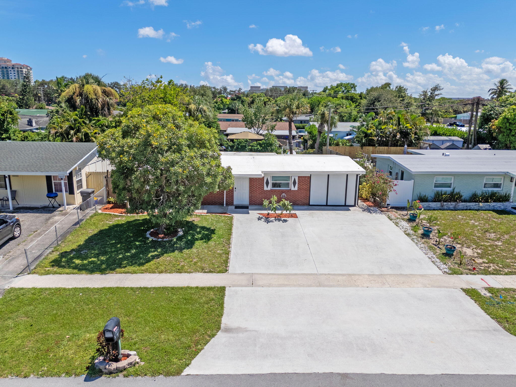 3852 Catalina Road Palm Beach Gardens, FL 33410 - Photo 1 of 48 a front view of a house with a yard and potted plants