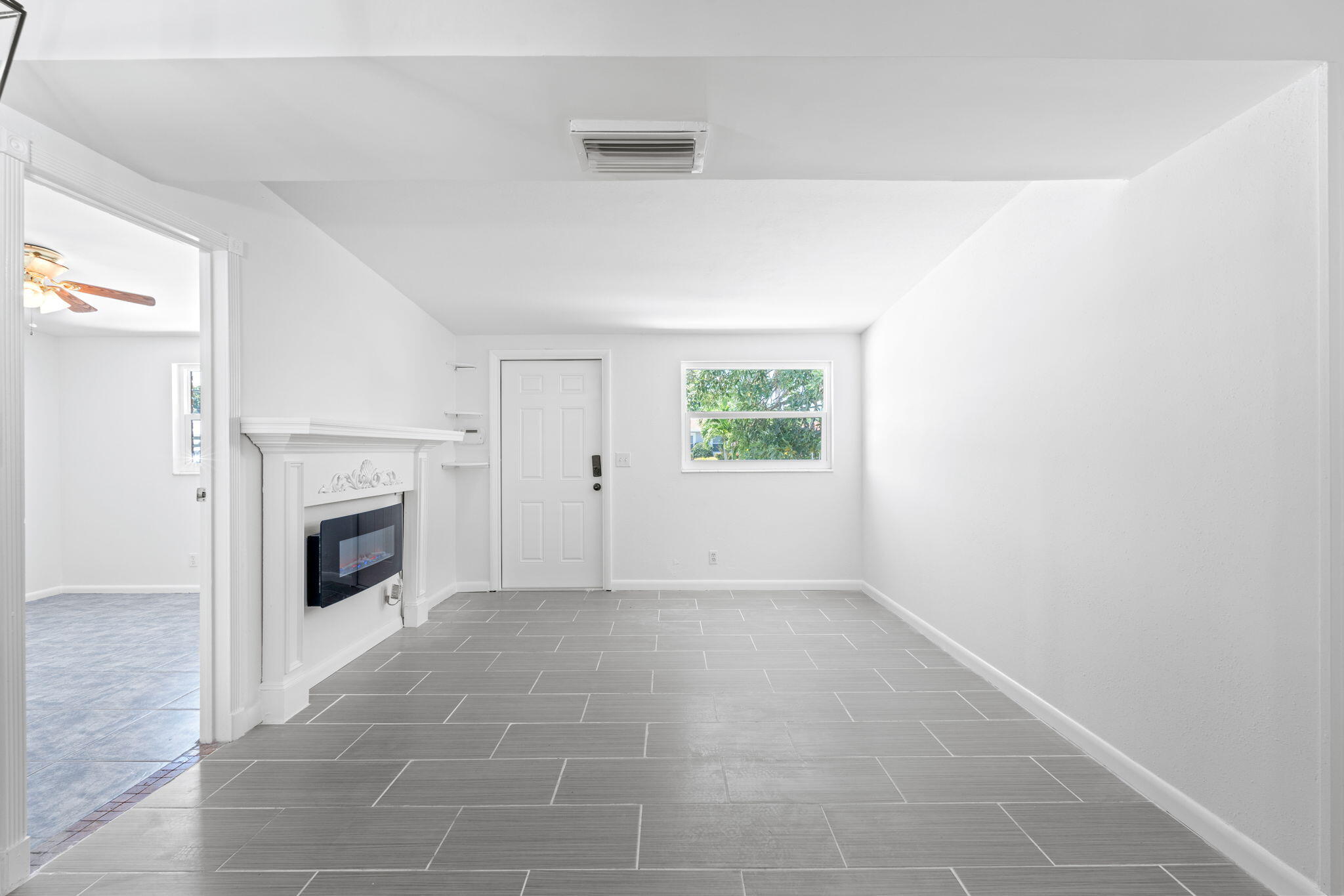 3852 Catalina Road Palm Beach Gardens, FL 33410 - Photo 12 of 48 a view of an empty room with a window and fireplace
