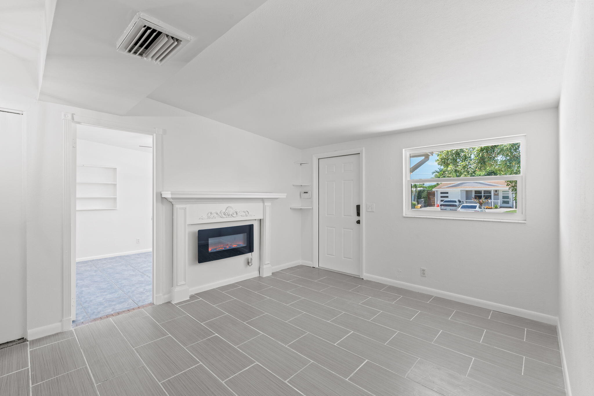 3852 Catalina Road Palm Beach Gardens, FL 33410 - Photo 13 of 48 an empty room with windows and fireplace