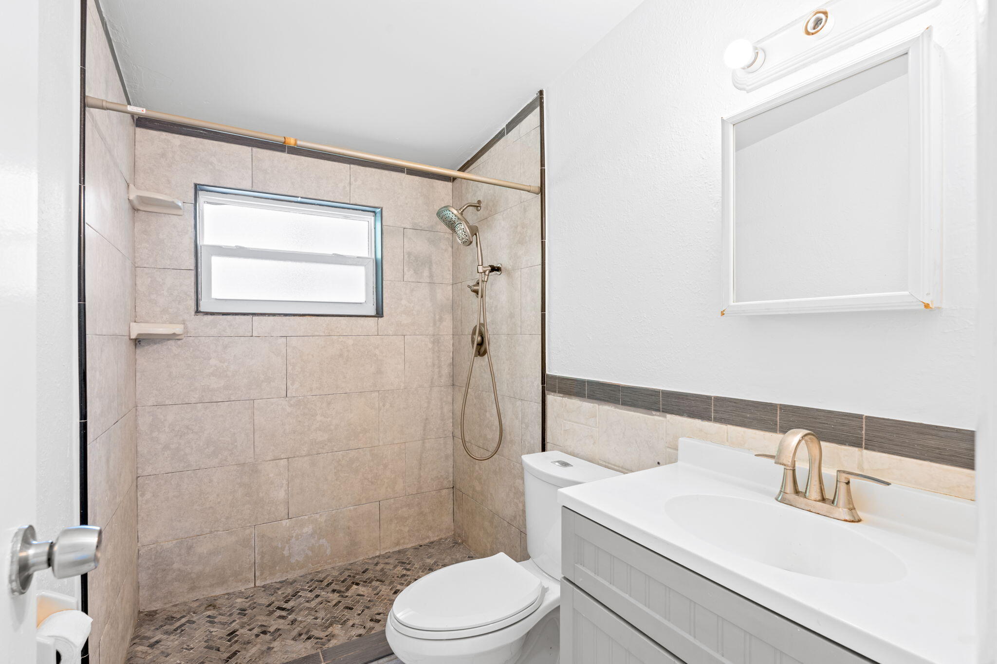 3852 Catalina Road Palm Beach Gardens, FL 33410 - Photo 16 of 48 a bathroom with a sink a toilet and shower
