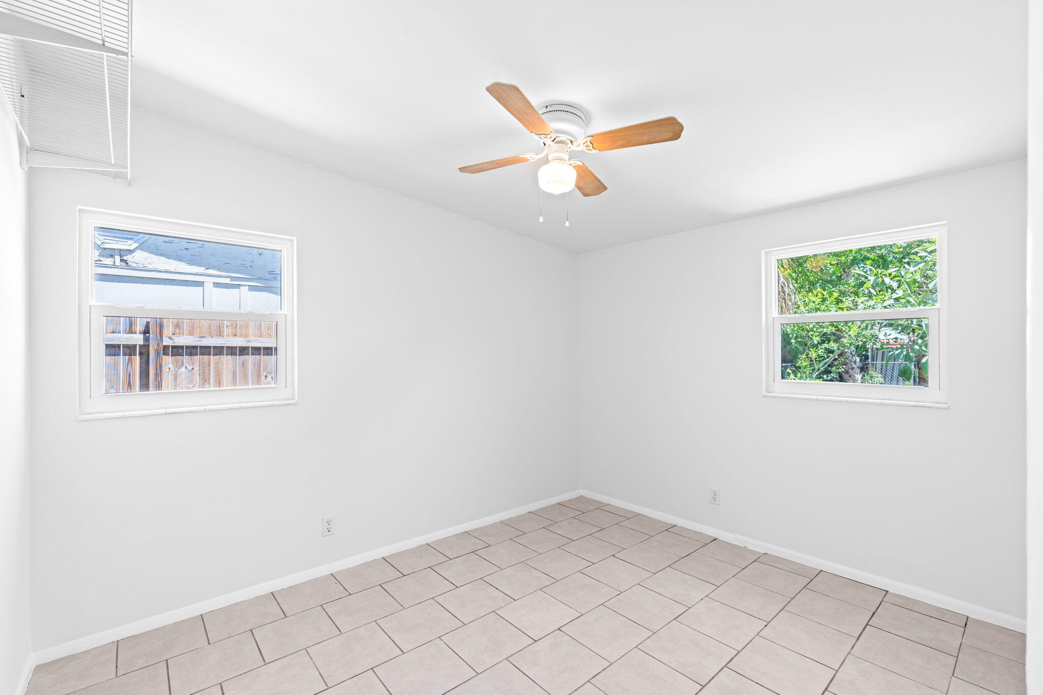 3852 Catalina Road Palm Beach Gardens, FL 33410 - Photo 18 of 48 an empty room with windows