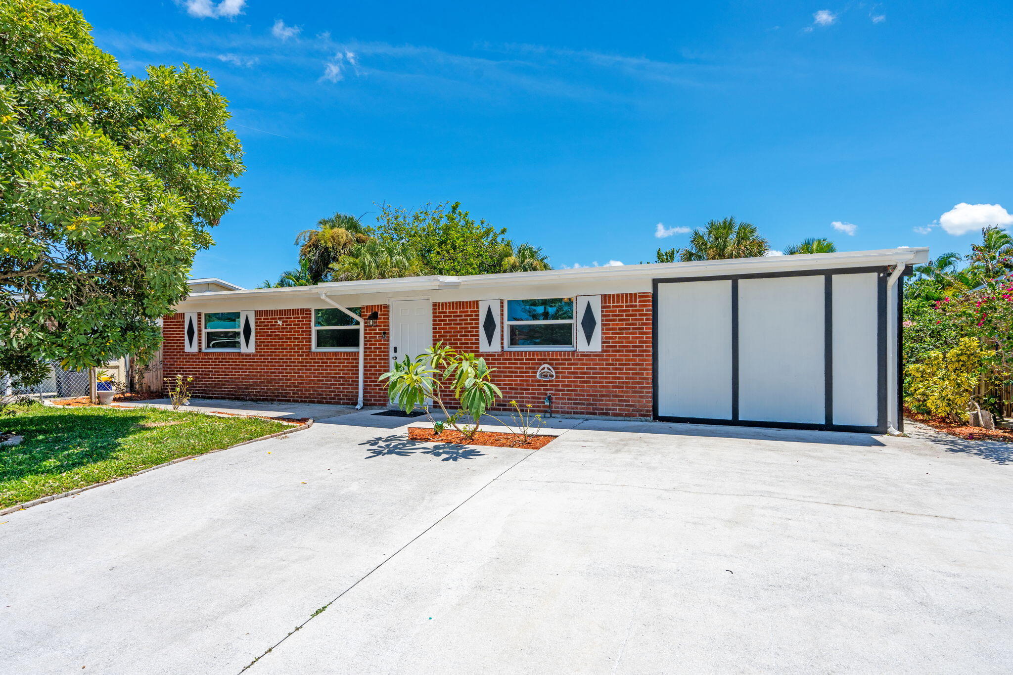 3852 Catalina Road Palm Beach Gardens, FL 33410 - Photo 2 of 48 a view of a house with backyard and a tree