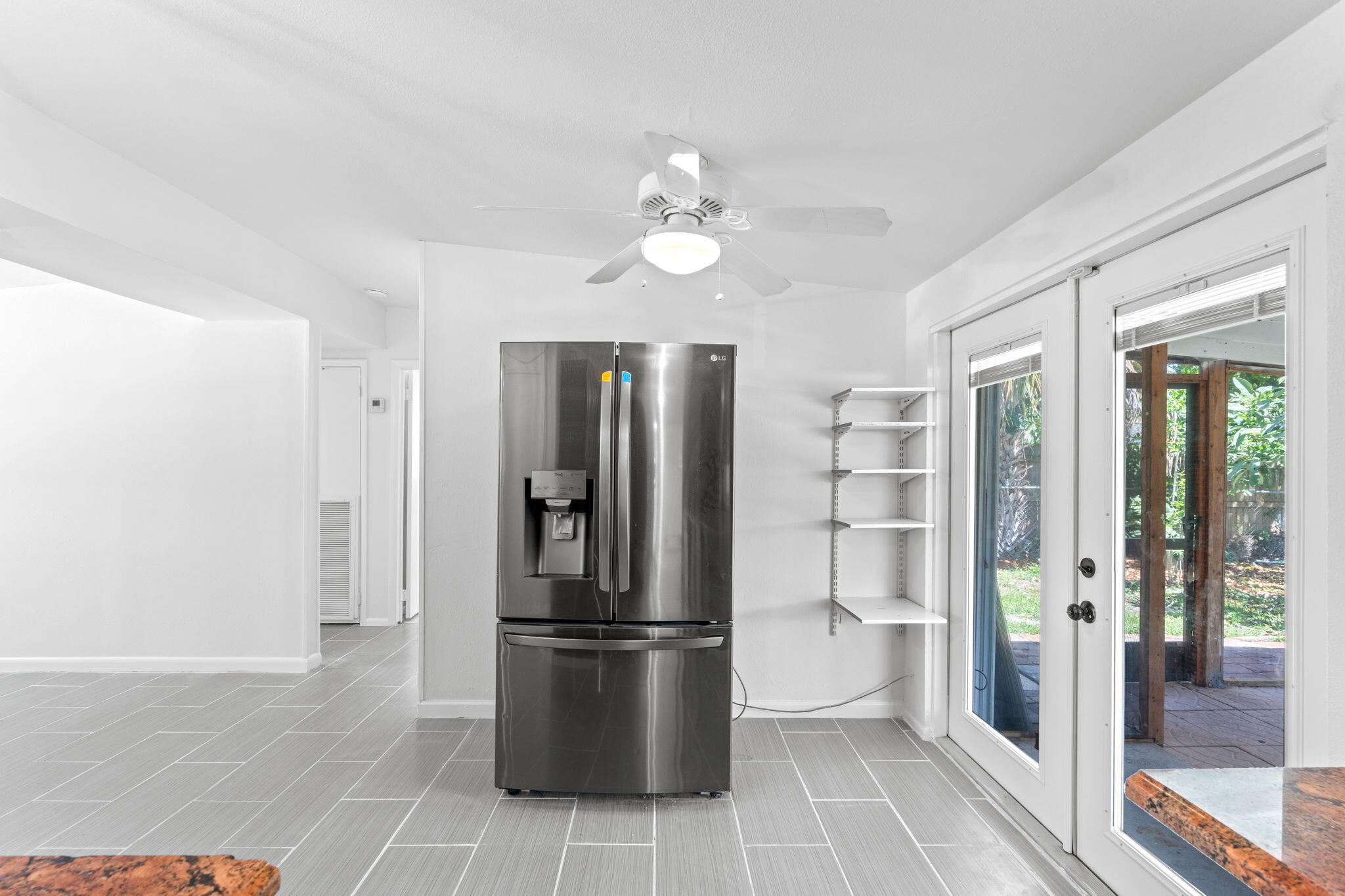 3852 Catalina Road Palm Beach Gardens, FL 33410 - Photo 22 of 48 a kitchen with stainless steel appliances a refrigerator and microwave