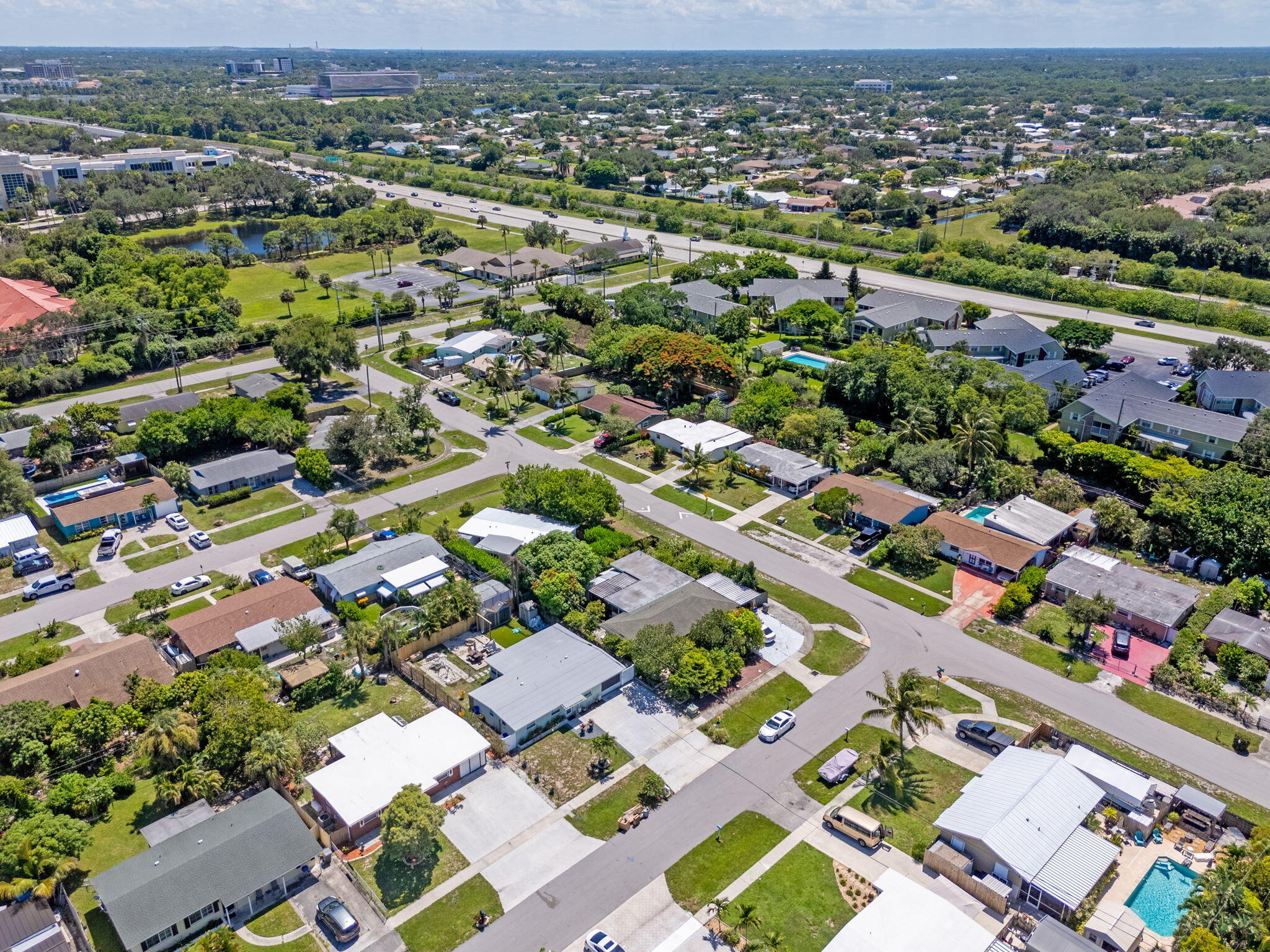 3852 Catalina Road Palm Beach Gardens, FL 33410 - Photo 38 of 48 an aerial view of a city with lots of residential buildings