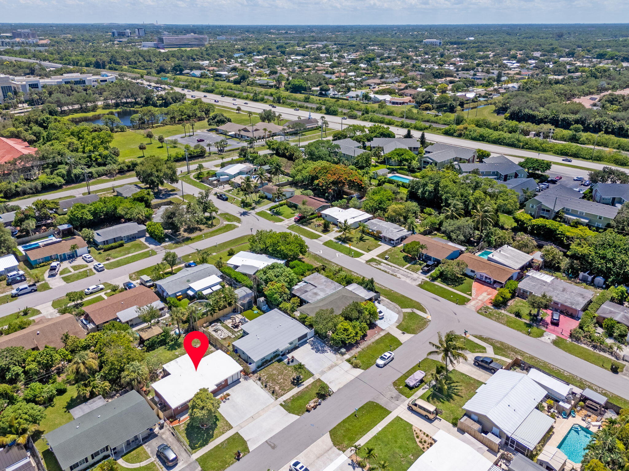 3852 Catalina Road Palm Beach Gardens, FL 33410 - Photo 39 of 48 an aerial view of a city with lots of residential buildings