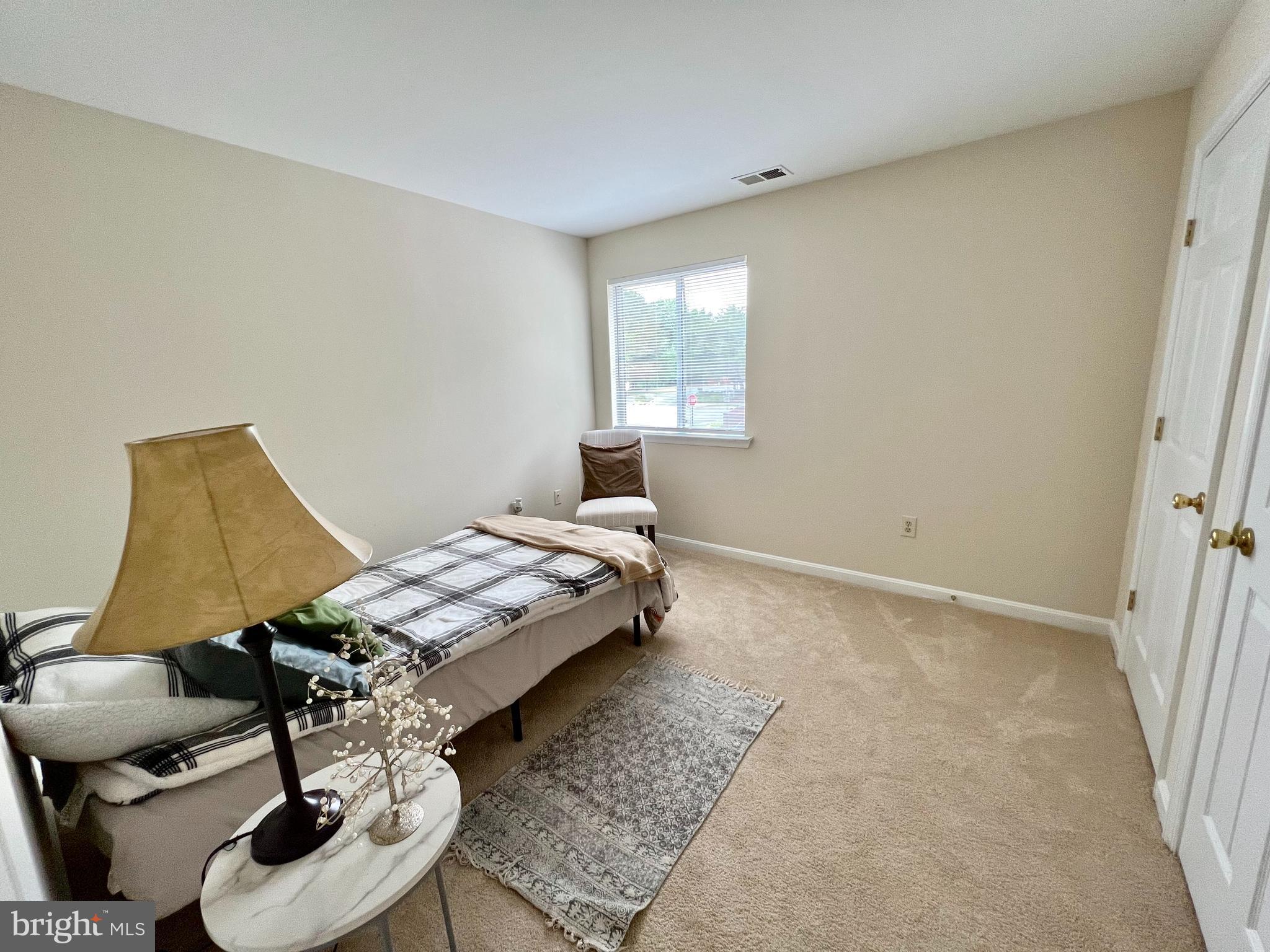 2104 Whitehall Road, Unit 1D Frederick, MD 21702 - Photo 5 of 9 a bedroom with a bed and chair