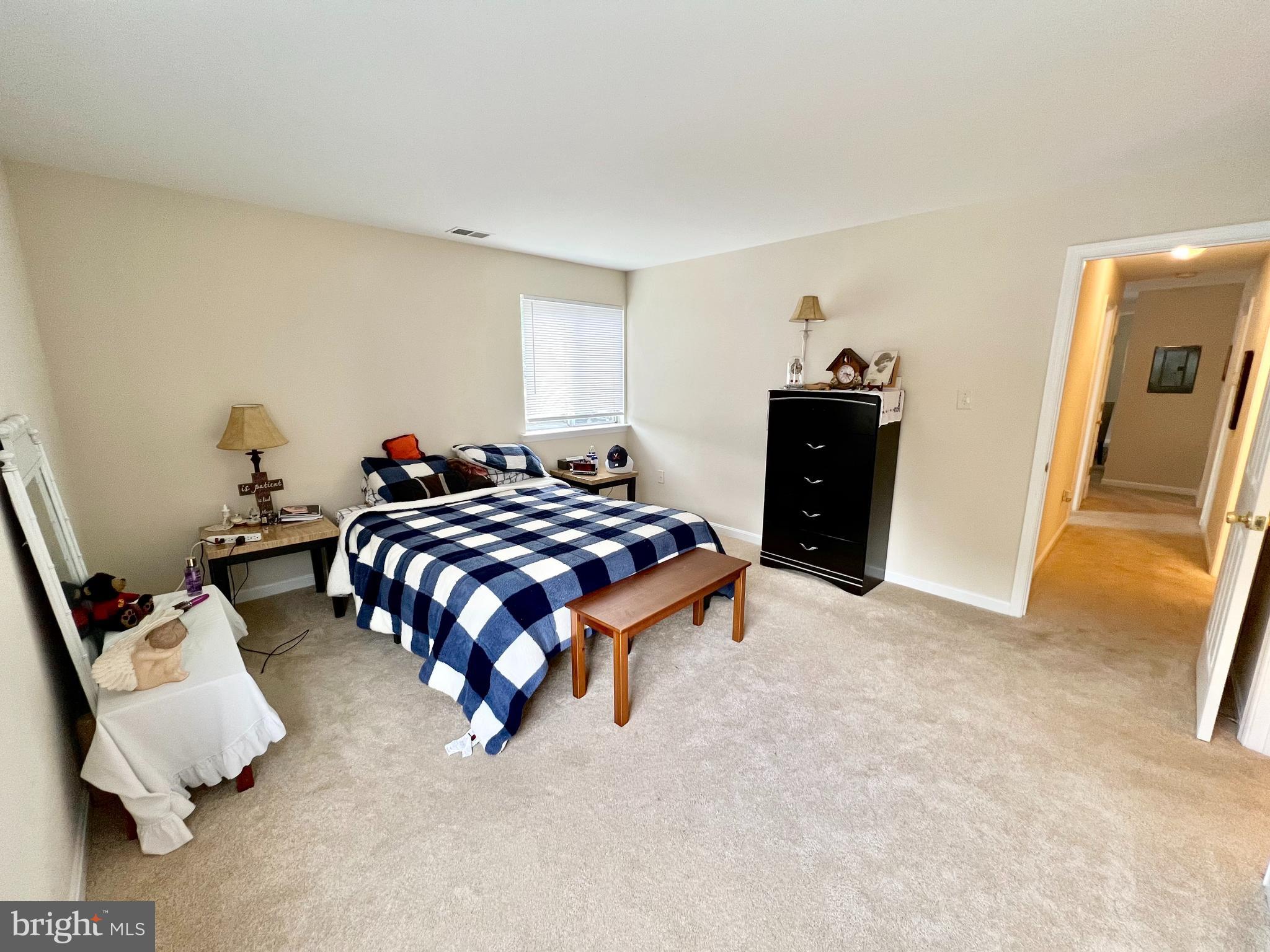 2104 Whitehall Road, Unit 1D Frederick, MD 21702 - Photo 7 of 9 a bedroom with a bed and wooden floor