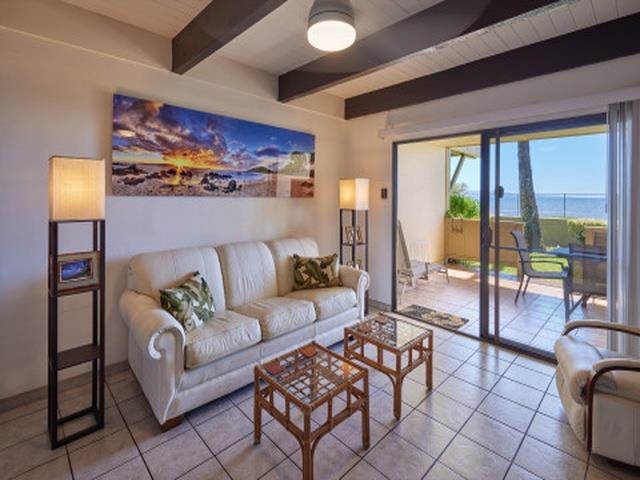 2075 South Kihei Road, Unit 114 Kihei, HI 96753 - Photo 4 of 14 a living room with furniture and a floor to ceiling window