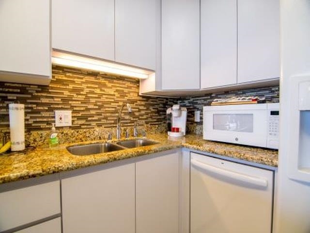 2075 South Kihei Road, Unit 114 Kihei, HI 96753 - Photo 8 of 14 a kitchen with sink cabinets and stove