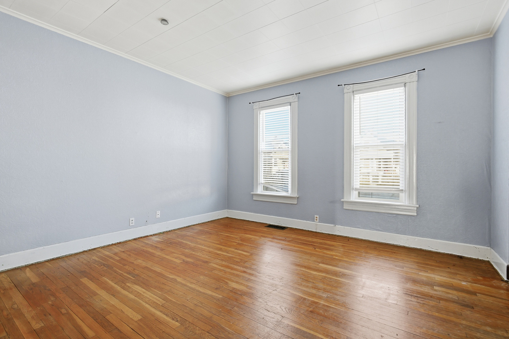 2115 West 4th Street Davenport, IA 52802 - Photo 9 of 24 a view of an empty room with wooden floor and a window