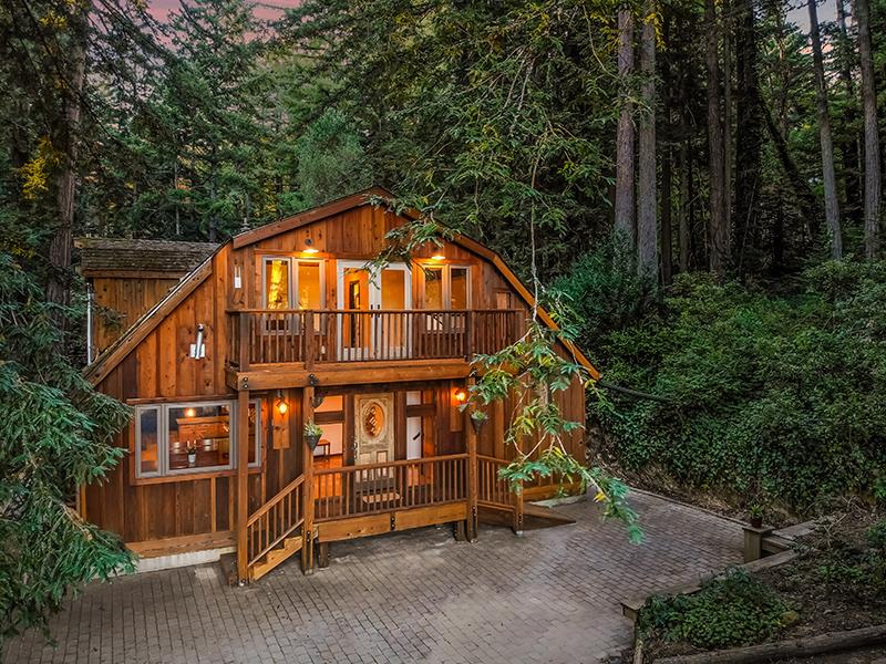 165 Old Ranch Road Woodside, CA 94062 - Photo 1 of 60 a view of a small house with large trees and wooden fence