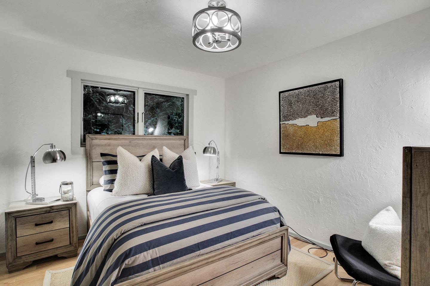 165 Old Ranch Road Woodside, CA 94062 - Photo 15 of 60 a bedroom with a bed and a window