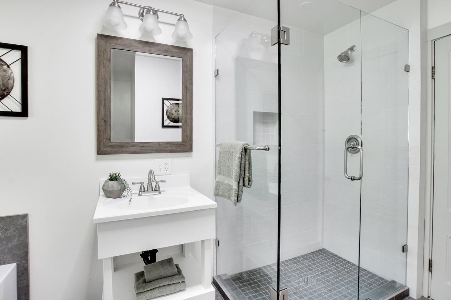 165 Old Ranch Road Woodside, CA 94062 - Photo 16 of 60 a bathroom with a sink a mirror and shower