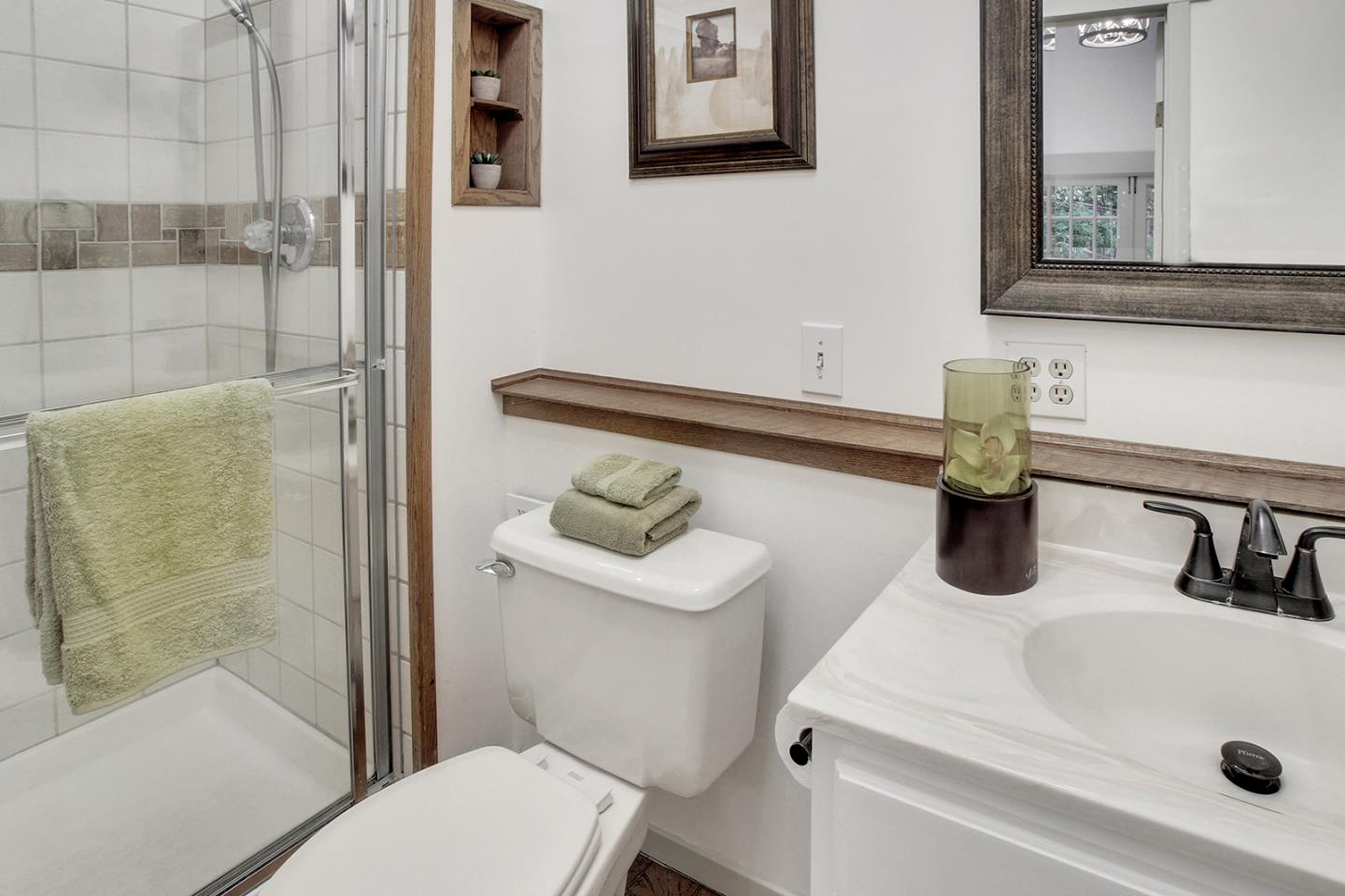 165 Old Ranch Road Woodside, CA 94062 - Photo 25 of 60 a bathroom with a sink a toilet and shower