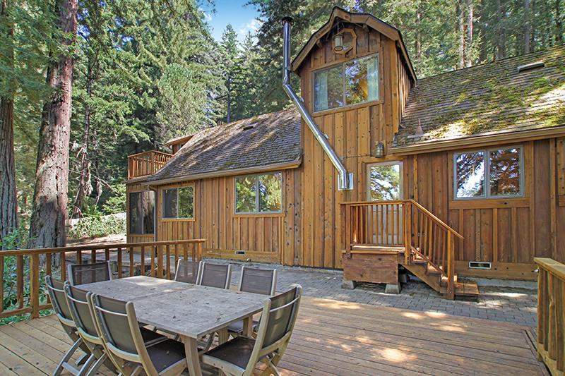165 Old Ranch Road Woodside, CA 94062 - Photo 51 of 60 a backyard of a house with barbeque oven table and chairs