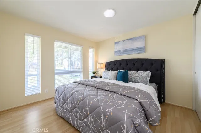 a bedroom with a bed and wooden floor