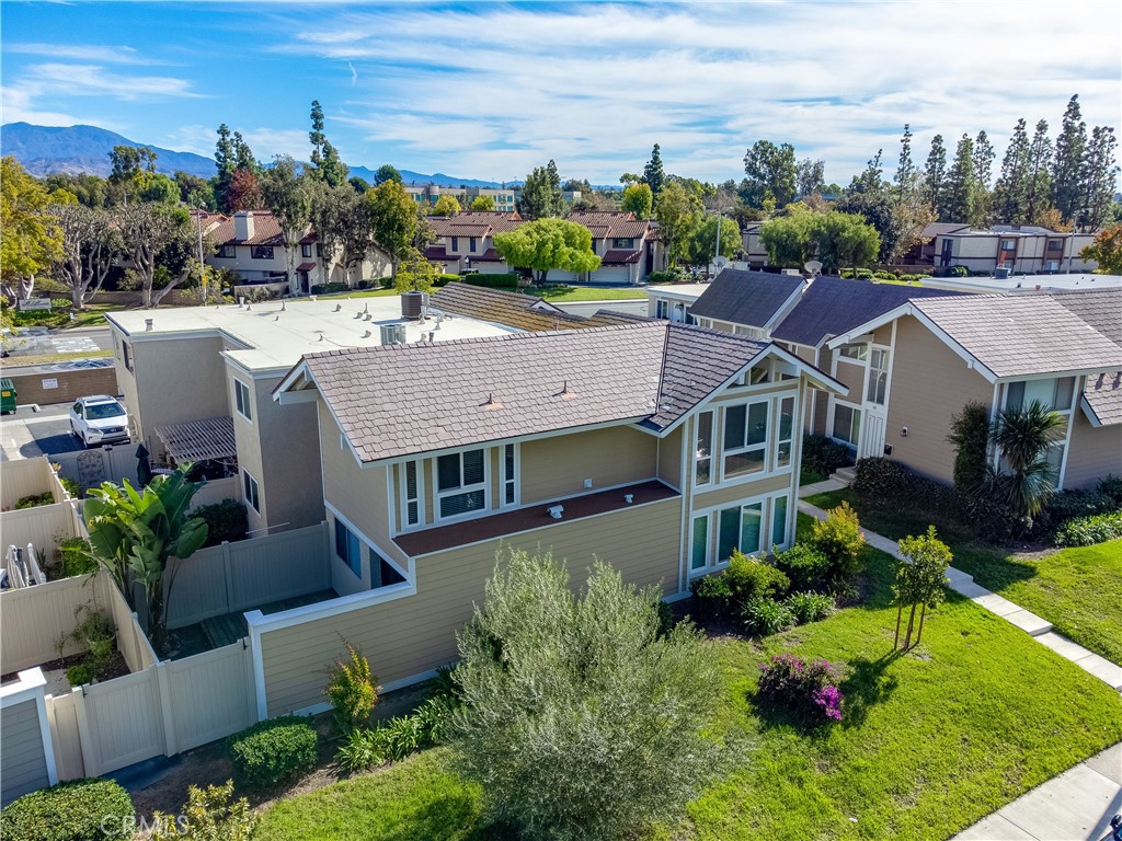 51 Oval Road, Unit 1 Irvine, CA 92604 - Photo 18 of 23 a aerial view of a house with a garden and lake view