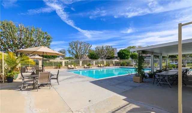 a view of a patio with a table and chairs under an umbrella