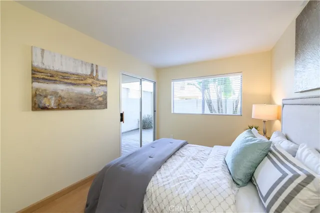 a bedroom with a bed and a painting on the wall