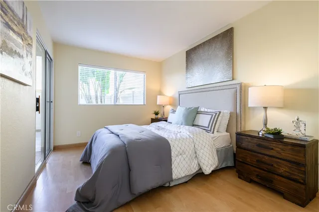 a bedroom with a bed and wooden floor