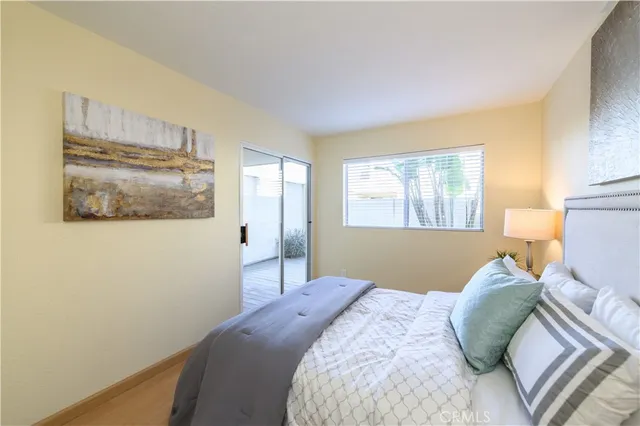 a bedroom with a bed and a painting on the wall